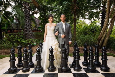 Couple Outside With Giant Chess Pieces