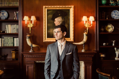Handsome Groom Poses in Historic Themed Bar
