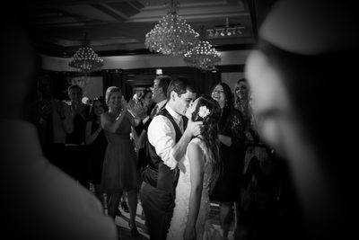 Bride and Groom Share Spontaneous Kiss on Dance Floor