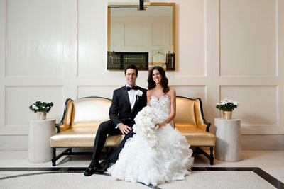 Bride and Groom Portrait in Modern Hotel on Gold Couch