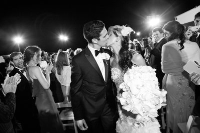 Bride and Groom Kiss During Ceremony Recessional