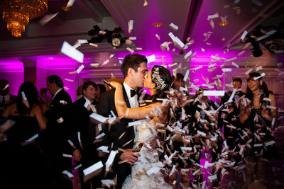 Bride & Groom Kiss Among Confetti at Wedding Reception