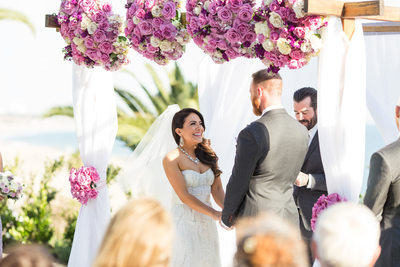 Exchanging Wedding Vows Under Lavender Rose Canopy