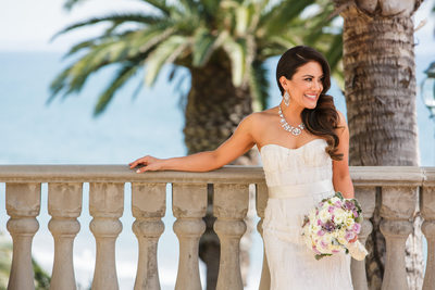 Bride Standing at Railing with Ocean View