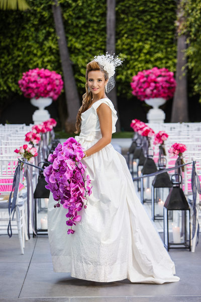 Bride Poses with Cascading Purple Orchid Bouquet