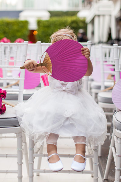 Flower Girl Hides Behind Large Hand Fan