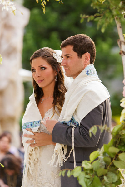 Bride and Groom Wrapped in Tallit Accept Rabbi Blessing
