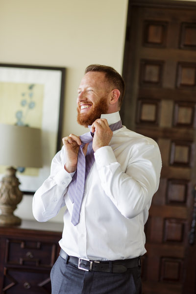 Groom Getting Ready for His Wedding With Lavender Tie