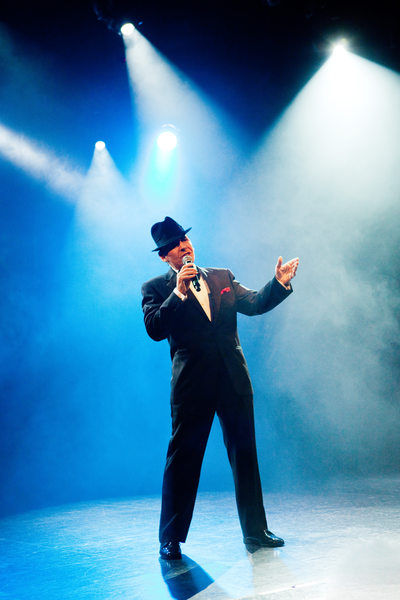 Frank Sinatra Impersonator Singing Under Stage Lighting