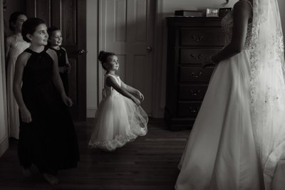 Candid Wedding Photography As Flower Girl Sees Bride 
