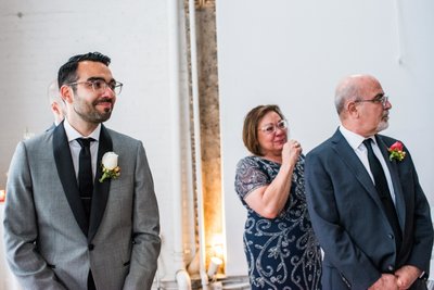 Groom and Parents Watch Bride Walk Down the Aisle 