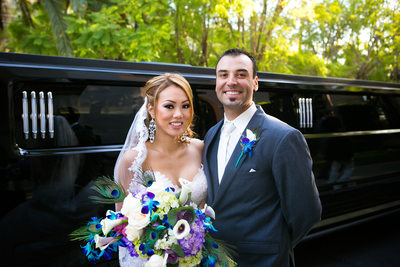 bride and groom with hummer limo
