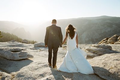 Yosemite elopement bride and groom walking away from camera