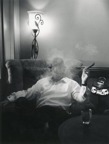Black and white photo of groom smoking cigar