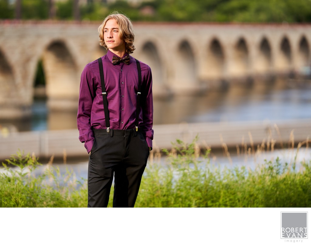 The Stone Arch Bridge in downtown Minneapolis makes striking backdrop for this boys senior portrait session