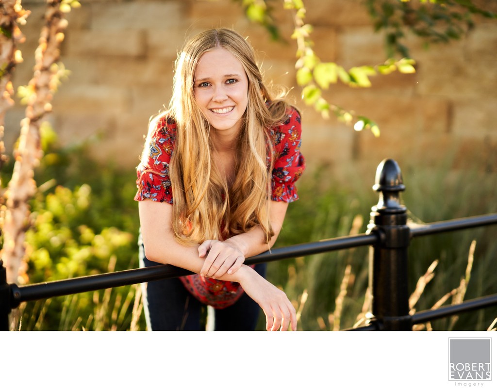 Sun kissed backlight, lights the hair of this beautiful high school senior