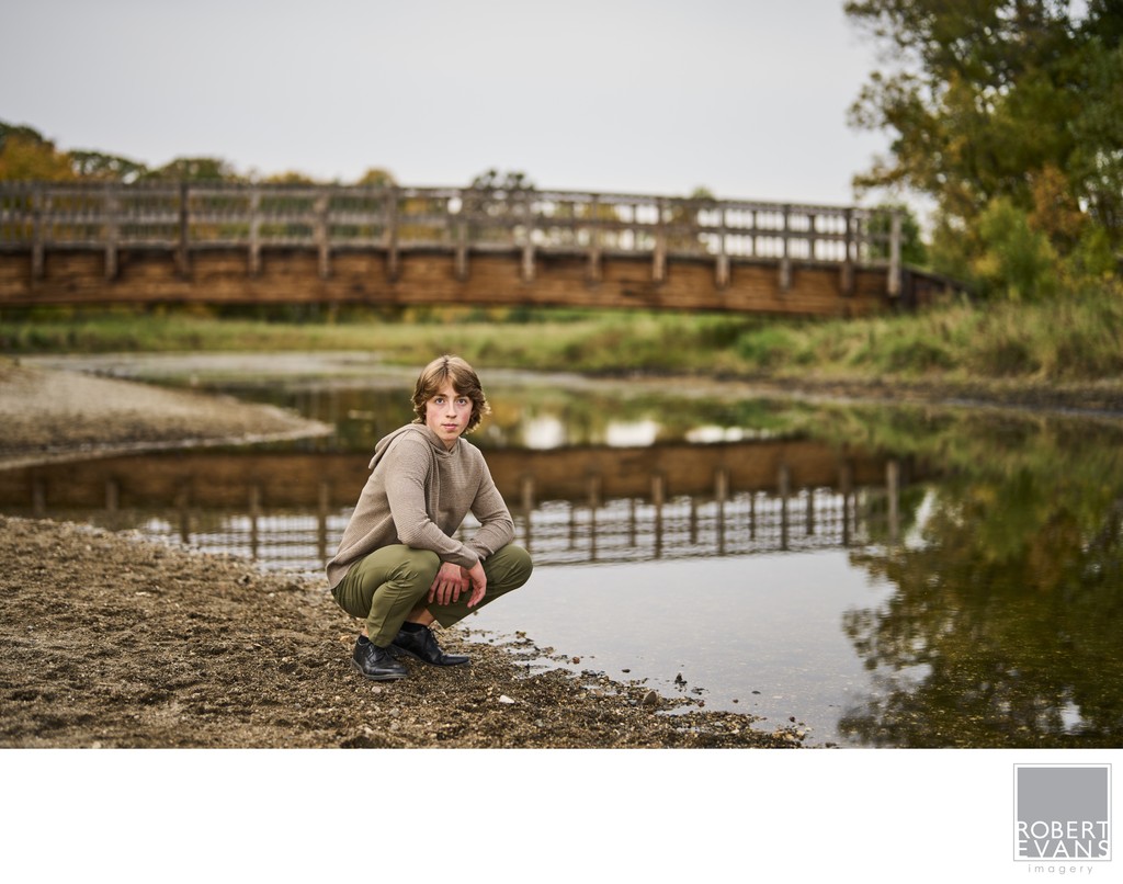 Captivating image of a high school senior next to a still creek