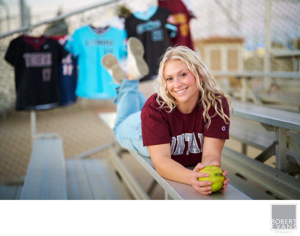 A softball themed portrait with her old softball jerseys