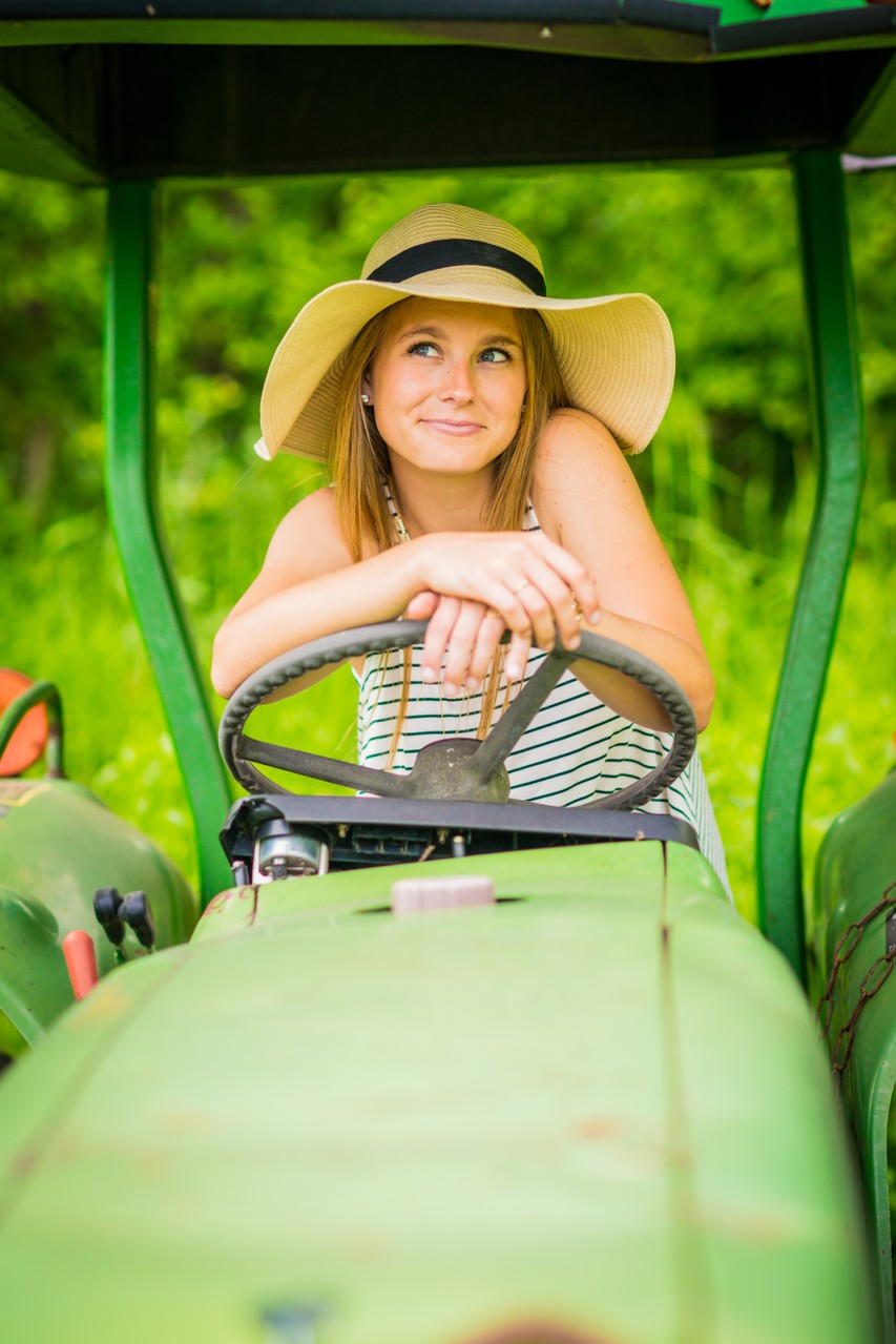 The fun and playful senior portrait was taken on a private farm in Orono