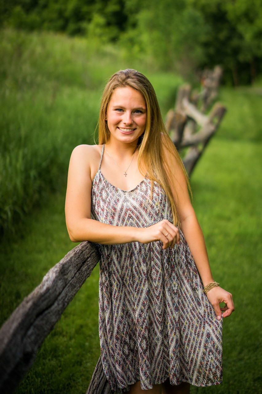 Senior Portrait Of A Female with old wooden fence in Orono Minnesota