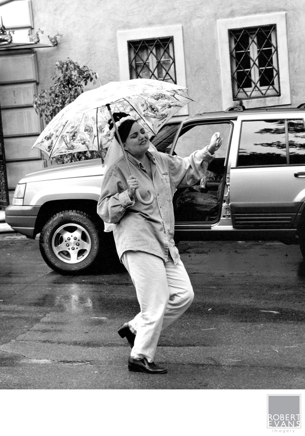 B&W Bride Dancing In The Rain With Joy