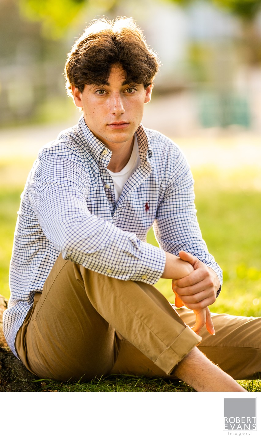 Seated backlit portrait of this senior boy is simple yet powerful.