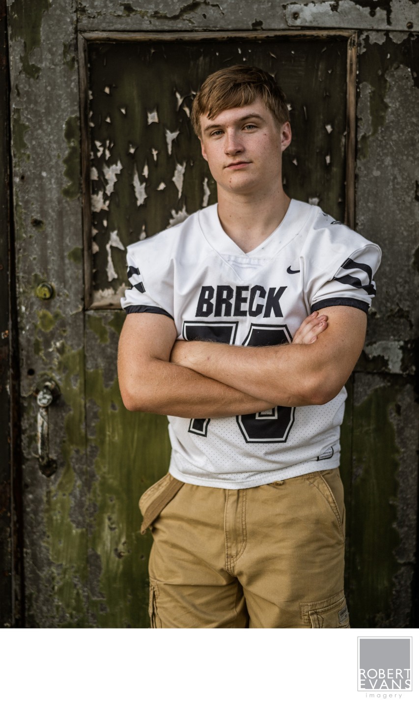 Breck High School senior portrait wearing his football Jersey