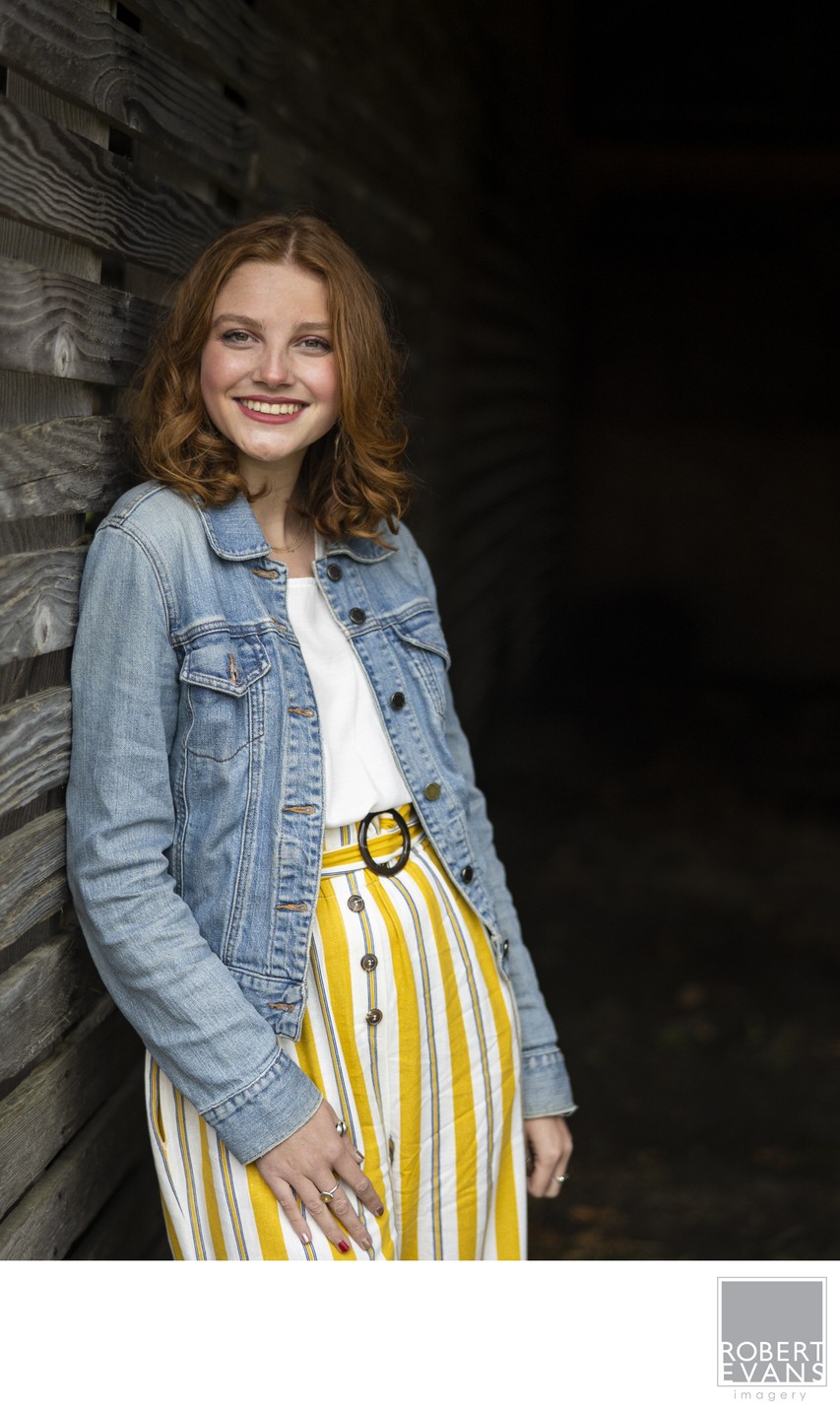 Redhead Senior Portrait In Old Wooden Structure