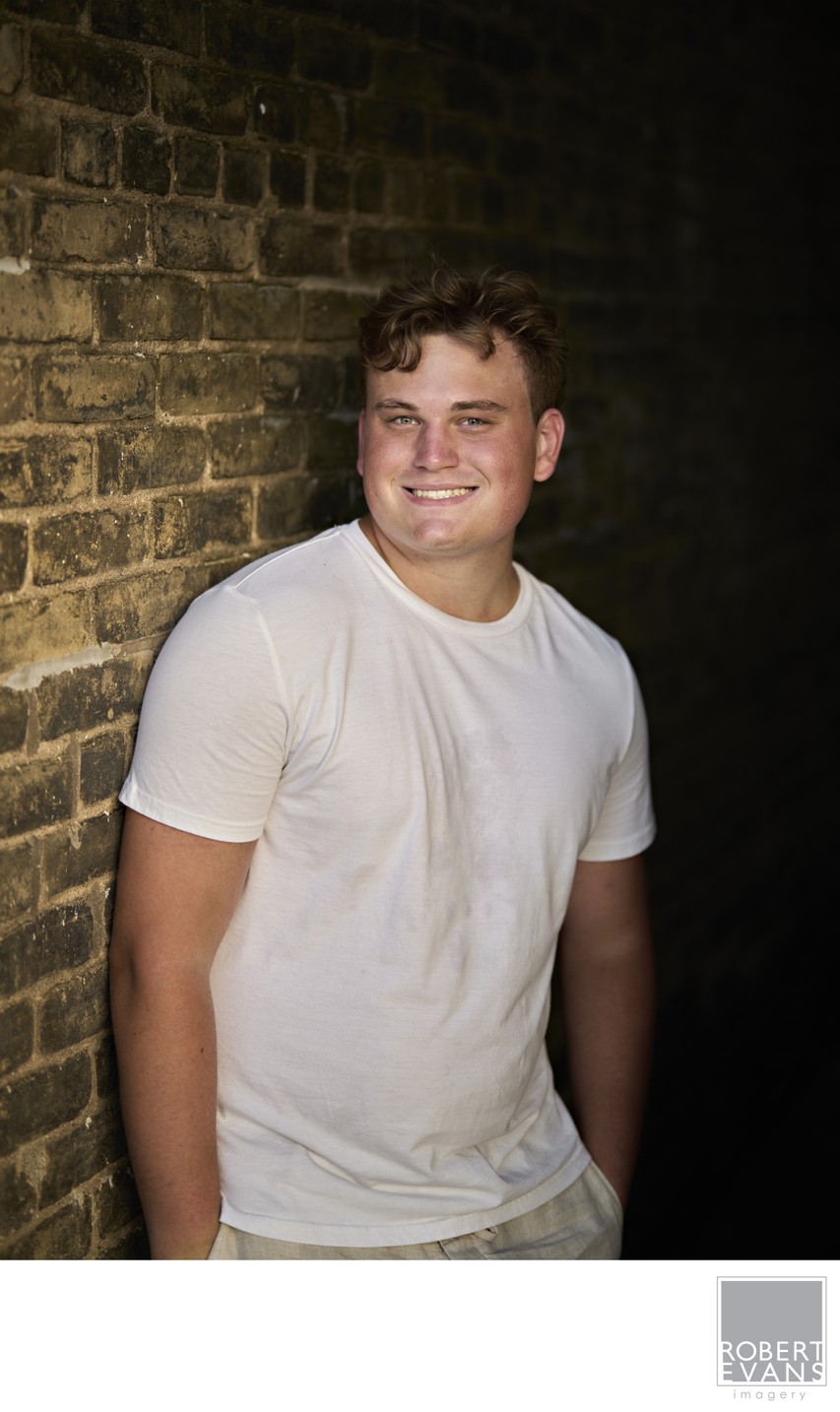Nice casual half-body pose up against a brick wall in downtown Chaska 