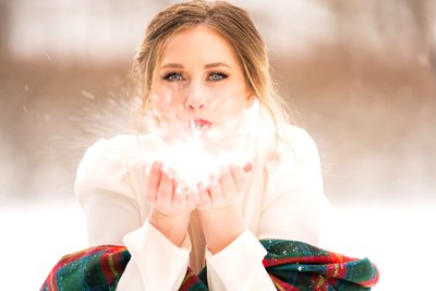 Bride blows snow at her winter wedding at the Arboretum