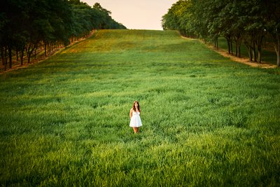 The Simplicity of this image girl in a white dress in the endless green grass