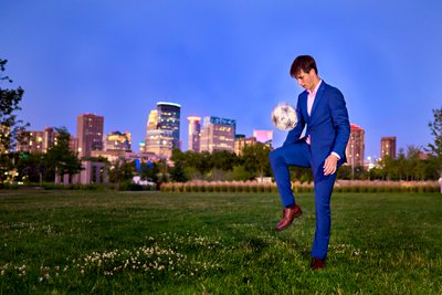 Minnetonka Senior Boy in a sharp Blue suit with a soccer ball. 