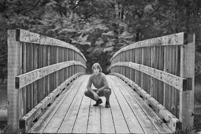  Senior portrait with leading lines on an old wooden bridge