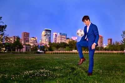 Minnetonka Senior Boy in a sharp Blue suit with a soccer ball. 