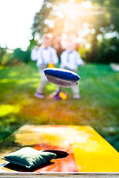 Ring Boys Play Corn Hole At The Wedding