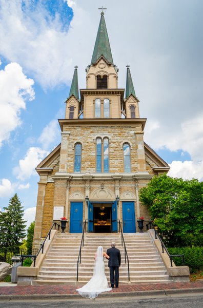Bride and Dad wait in front of the Our Lady of Lourdes Catholic Church 