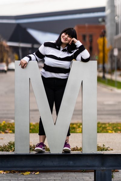High School Senior Poses Next To A Giant 