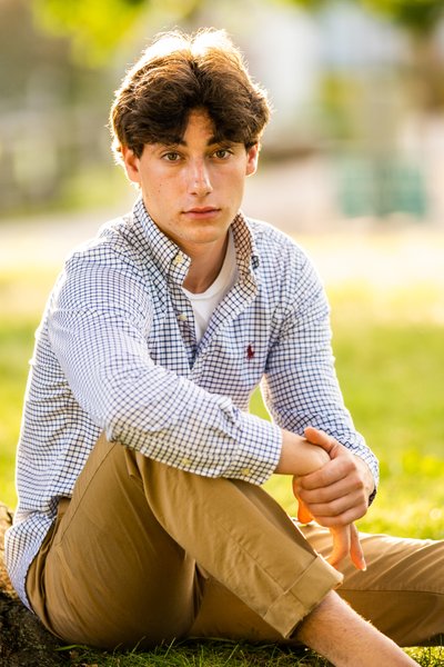 Seated backlit portrait of this senior boy is simple yet powerful.