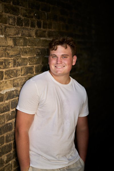 Nice casual half-body pose up against a brick wall in downtown Chaska 