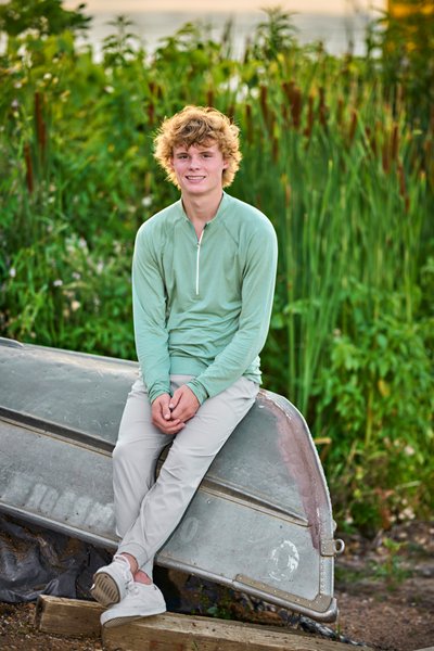 Soft late afternoon light and complimentary colors between outfit and green Cattails