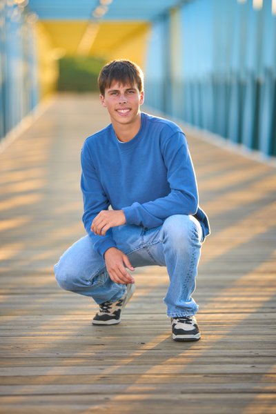 Minnetonka Senior portrait of a boy posing on a bridge