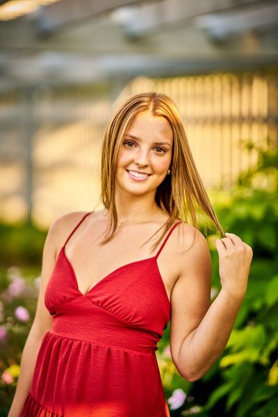 Elegant senior portrait of this Southwest Christian Senior in a Ruby Red dress with beautiful hair light