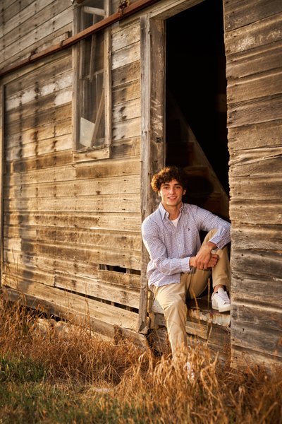 A relaxed late afternoon senior portrait of Chaska senior in the doorway.