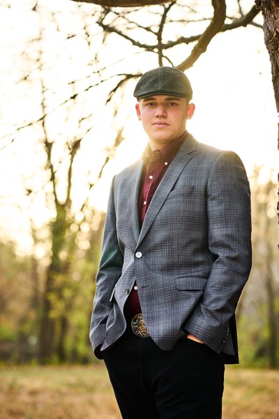 Stylish Minnetonka senior boy wearing a drivers cap and a grey sports coat