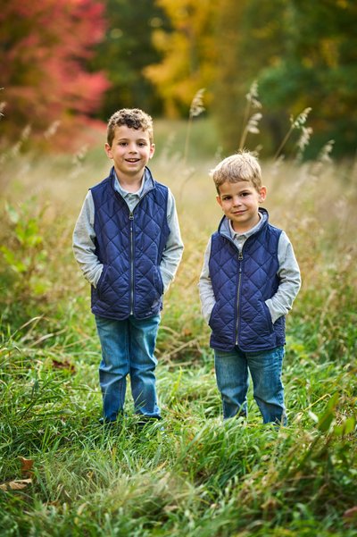 Two brothers in matching vests