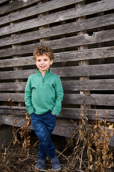 Boy against rustic wood wall