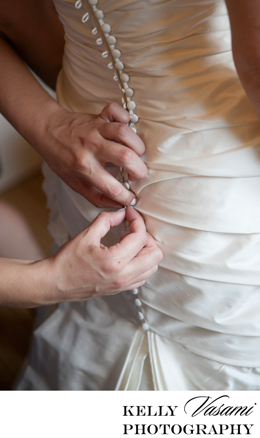 Buttoning Up The Bride's Wedding Gown | White Plains 