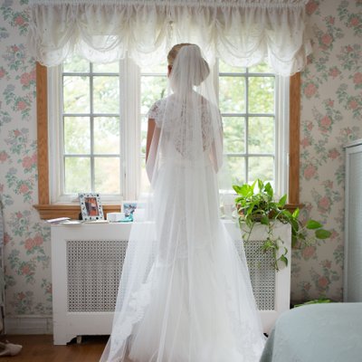Full length bride looking out window | Westchester NY