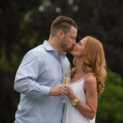 Engaged Couple Shares a Champagne and a Kiss