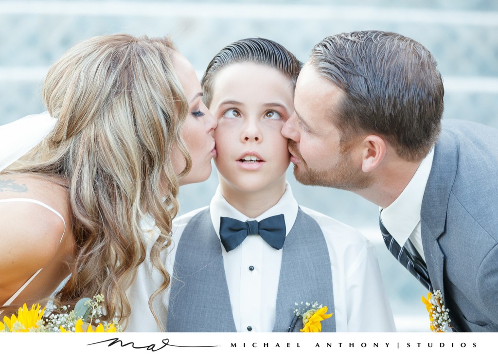 Bride and Groom Kiss Son Before Ceremony